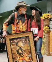  ?? Jon Shapley / Houston Chronicle ?? Richard Gruen hugs Lucy Chen, as he holds her painting.