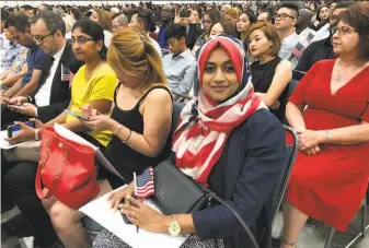  ?? Amy Taxin / Associated Press ?? Sameeha Alkamalee Jabbar attends a naturaliza­tion ceremony Sept. 18 in Los Angeles. Processing applicatio­ns for citizenshi­p in many parts of the country can take a year or more.