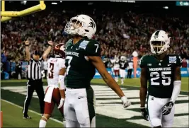  ?? ASSOCIATED PRESS ?? MICHIGAN STATE WIDE RECEIVER CODY WHITE (7) celebrates a touchdown catch against Washington State during the first half of the Holiday Bowl on Thursday in San Diego.