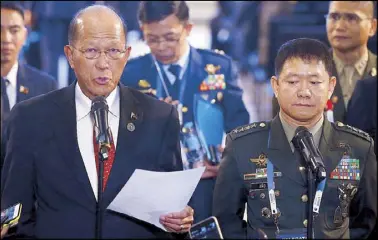  ?? AP ?? Defense Secretary Delfin Lorenzana reads a statement announcing the end of combat in Marawi City at the ongoing Asean Defense Ministers’ Meeting in Clark, Pampanga yesterday. At right is Armed Forces chief Gen. Eduardo Año.