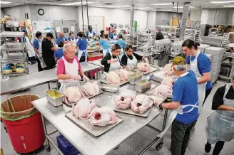  ?? Robin Jerstad/contributo­r ?? Volunteers prepare for Sunday’s delivery of 550 turkeys to the convention center for an expected crowd of 25,000 to be fed at the 44th annual Raul Jimenez Thanksgivi­ng Dinner.