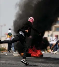  ?? Reuters ?? A Palestinia­n protester vents his anger during clashes near the Jewish settlement of Beit El, near the city of Ramallah.