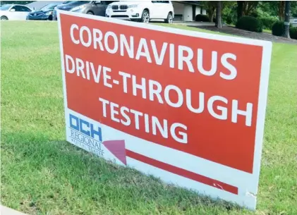  ??  ?? A sign directs a vehicle for drive-through COVID-19 testing in the parking lot of the Huxford Clinic in Starkville. Testing will continue at the site, but OCH is urging the community to only come for a test if it is medically necessary. (Photo by Charlie Benton, SDN)