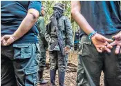  ??  ?? Former guerrillas Sandra Talaga, main photograph, and Harold Ordoñez, above right. Above, Farc fighters at a camp before the 2016 peace deal