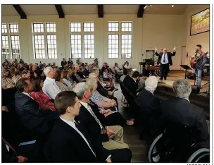  ?? AP/ERIC GAY ?? Pastor Frank Pomeroy (back right) raises his hands Sunday as he speaks during a dedication ceremony for a new sanctuary and memorial room at the First Baptist Church in Sutherland Springs, Texas.