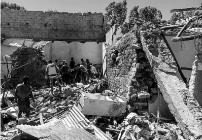  ?? AP ?? Residents sift through rubble from a destroyed building at the scene of an airstrike in Mekele, in the Tigray region of northern Ethiopia yesterday.