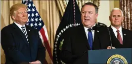  ?? DOUG MILLS / THE NEW YORK TIMES ?? New U.S. Secretary of State Mike Pompeo (center), flanked by President Donald Trump and Vice President Mike Pence, speaks Wednesday during a ceremonial swearing-in at the State Department.