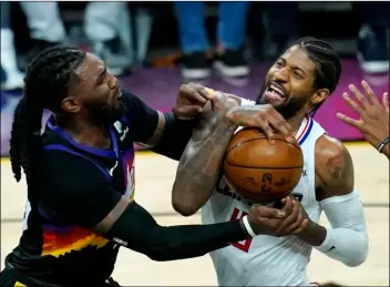  ?? AP Photo/Ross D. Franklin ?? Los Angeles Clippers guard Paul George (right) reacts as he is stopped in the lane by Phoenix Suns forward Jae Crowder (left) during the second half of Game 1 of the NBA basketball Western Conference finals on Sunday in Phoenix.