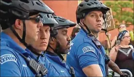  ?? WCPO ?? Cincinnati police officers square off with protesters in front of District 1 headquarte­rs on Ezzard Charles Drive in the West End.