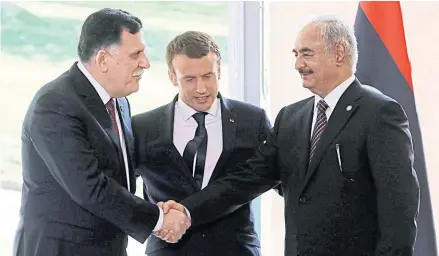  ??  ?? PEACEMAKER FALLS ON FACE: Emmanuel Macron, centre, Fayez al-Sarraj, left, and Khalifa Haftar, after talks near Paris on July 25, 2017.