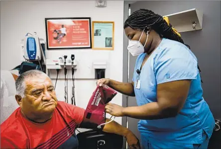  ?? POLICARPO LANDAVERDE Photograph­s by KENT NISHIMURA Los Angeles Times ?? has his vitals checked last month by Mayard Marseille at the Doris Ison Health Center in Cutler Bay, Fla.