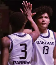  ?? DAN FENNER — FOR MEDIANEWS GROUP ?? Oakland University’s Trey Townsend, right, an Oxford graduate, high-fives teammate Micah Parrish during Tuesday’s Horizon League Tournament quarterfin­al win.