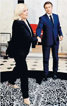  ?? ?? Weak hand: Macron holds talks with the National Rally party’s Marine Le Pen after his defeat in the legislativ­e poll