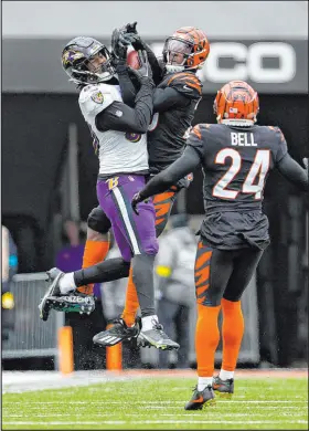  ?? Jeff Dean The Associated Press ?? Ravens tight end Isaiah Likely makes a catch against Bengals cornerback Eli Apple on Jan. 8 during Cincinnati’s 27-16 win.