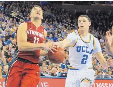  ?? REED SAXON/ASSOCIATED PRESS ?? UCLA’s Lonzo Ball (2) defends as Stanford’s Dorian Pickens drives to the basket. Ball scored 21 points as the Bruins won 89-75.