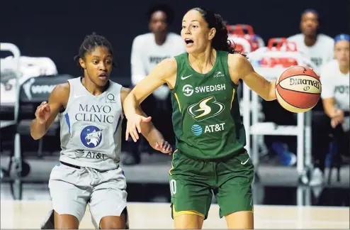  ?? Chris O’Meara / Associated Press ?? Seattle Storm guard Sue Bird, right, drives around Minnesota Lynx guard Crystal Dangerfiel­d during the second half of Game 2 of a WNBA playoff semifinal last Thursday.