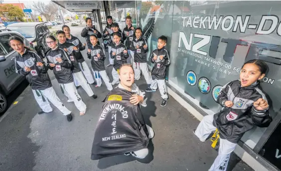  ?? Photo / Paul Taylor ?? NZ Internatio­nal Taekwon-Do Federation (NZITF) regional director and coach Ben Evans with the squad who are off to the world champs in Argentina.