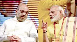  ?? —PTI ?? `16,000 CRORE will be spent to provide free electricit­y connection to poor, says Modi. Prime Minister Narendra Modi with BJP President Amit Shah at the party’s national executive meeting in New Delhi on Monday.
FOUR CRORE out of 25 crore families...