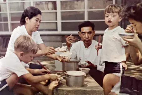  ??  ?? The Platt brothers eat a late lunch with cook Mr. Yu and his family in Taiwan, 1963.