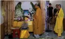  ??  ?? Family members and neighbours of Pham Thi Tra My attend a praying ceremony with Buddhist monks in front of a makeshift shrine. Photograph: Linh Pham/ Getty Images