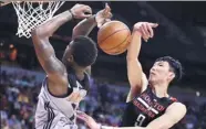  ?? AP ?? Houston Rockets' Zhou Qi defends against Phoenix Suns' Marquese Chriss in NBA summer league play.