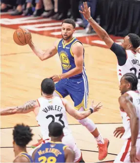  ?? KYLE TERADA/USA TODAY SPORTS ?? Warriors guard Stephen Curry passes the ball during the fourth quarter Sunday as the Raptors employed a box-and-one defense.