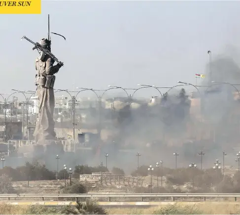  ?? AHMAD AL-RUBAYE / AFP / GETTY IMAGES ?? Smoke billows as Iraqi forces advance towards the centre of Kirkuk during an operation against Kurdish fighters on Monday. Iraqi soldiers seized Kirkuk and its nearby oilfields as they swept across the disputed province following soaring tensions over...