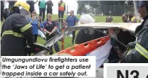  ?? ?? Umgungundl­ovu firefighte­rs use the ‘Jaws of Life’ to get a patient trapped inside a car safely out.