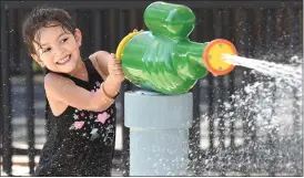  ?? RECORDER PHOTO BY CHIEKO HARA ?? Daretzy Moreno, 4, takes aim at her friends Saturday, July 14, at Fallen Heroes Park in Portervill­e. Community members now can enjoy the Splash Pad from 4 p.m. to 6 p.m. on weekdays and from 3p.m. to 5p.m. on weekends.