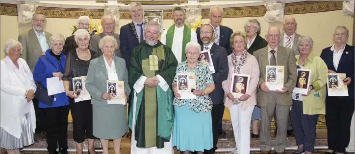  ??  ?? Monsignor Enda Lloyd, Fr John Daly PP and chairman of the Pioneer Associatio­n Matt Boylan celebratin­g 100 years of pioneers in the parish with the members who received silver, gold and diamond pins.