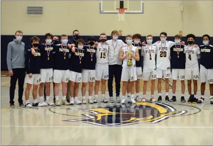  ?? OWEN MCCUE — MEDIANEWS GROUP ?? The Pope John Paul II boys basketball poses with the District 1-4A championsh­ip trophy after defeating New Hope Solebury on Wednesday.