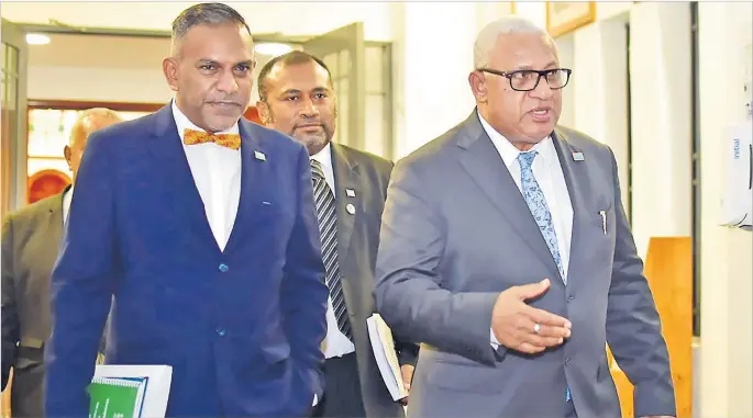  ?? Picture: JOVESA NAISUA ?? PM Voreqe Bainimaram­a is followed by Health Minister Dr Ifereimi Waqainabet­e and MP Faiyaz Koya after the Supplement­ary Budget address on Thursday night.