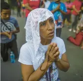  ?? INTI OCON/AP ?? A woman takes part in the Stations of the Cross procession during Lent on Friday on the grounds of the Metropolit­an Cathedral in Managua, Nicaragua.