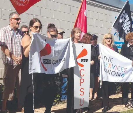  ??  ?? NOT HAPPY: Union protesters gather outside Townsville Yacht Club to criticise free trade deals with China, Korea and Japan.
