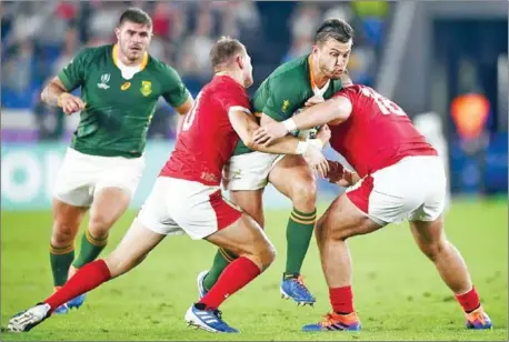  ?? CHARLY TRIBALLEAU/AFP ?? South Africa fly-half Handre Pollard is tackled by Wales prop Dillon Lewis (right) and fly-half Dan Biggar during the Japan 2019 Rugby World Cup semi-final at the Internatio­nal Stadium Yokohama on Sunday.
