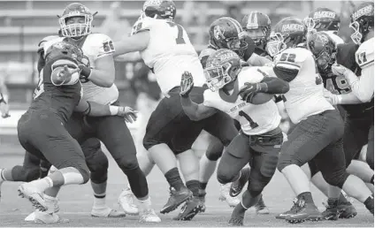  ?? ALGERINA PERNA/BALTIMORE SUN ?? Mount Union’s B.J. Mitchell looks for room to run in the first half. After building a 21-7 lead early in the game, Johns Hopkins was pounded by Mount Union in the second half. Blue Jays quarterbac­k Jonathan Germano was sacked five times.