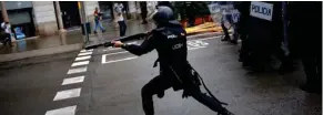  ?? (Photo by Emilio Morenatti, AP) ?? Spanish riot police shoots rubber bullet straight to people trying to reach a voting site at a school assigned to be a polling station by the Catalan government in Barcelona, Spain, Sunday, 1 Oct. 2017. Spanish riot police have forcefully removed a few hundred would-be voters from several polling stations in Barcelona.