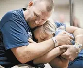  ?? JOHN LOCHER/AP ?? Shooting victim Kurt Fowler embraces his daughter Timori, 10, at Sunrise Hospital in Las Vegas on Wednesday.