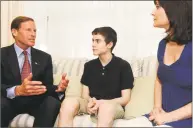  ?? Hearst Connecticu­t Media file photo ?? U. S. Sen. Richard Blumenthal, D- Conn., speaks with Max Wheeler, 13, and his mother, Maria, in their Trumbull home in 2013. Max and his parents sought Blumenthal’s help in dealing with their health insurance company.