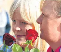  ?? Pictures: Gareth Jennings. ?? Left: Walkers set out at the start of the event in Dundee; and, above, some people threw roses into the River Tay as a memorial to those who have lost their lives to substance misuse.