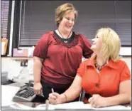  ?? Staff Photo by Ashlee Culverhous­e ?? Tracy Brown, left, and Fancy Moran, clerk of Catoosa County Superior Court, share a laugh at Moran’s desk in the Catoosa County Courthouse in Ringgold, Ga.