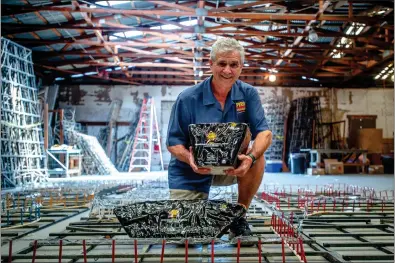  ?? SCNG FILE PHOTOS ?? Jim Souza, Pyro Spectacula­rs president and CEO, shows different types of aerial shells inside a fireworks assembly building in Rialto.