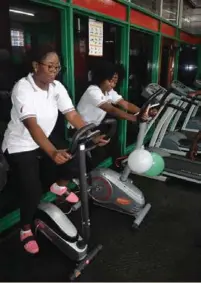  ??  ?? WCFCB staff Lucy Shengamo (left) and Carol Salupembe working out in the gym.