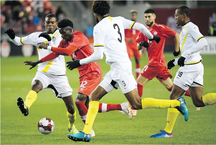  ?? — THE CANADIAN PRESS ?? Whitecaps’ teen sensation Alphonso Davies (12) plays left back for Canada. It’s a position he could play with European powerhouse Bayern Munich.