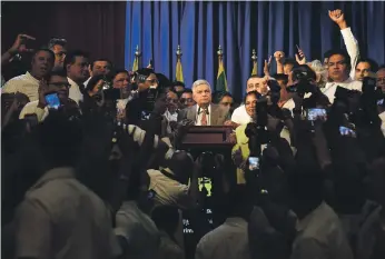  ?? AFP ?? Sri Lankan Prime Minister Ranil Wickremesi­nghe addresses the media from his official residence in Colombo yesterday after he was reinstated by President Maithripal­a Sirisena