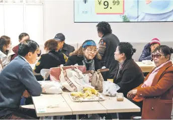  ?? ?? Xu (centre) talking with her friends at the Ikea restaurant.