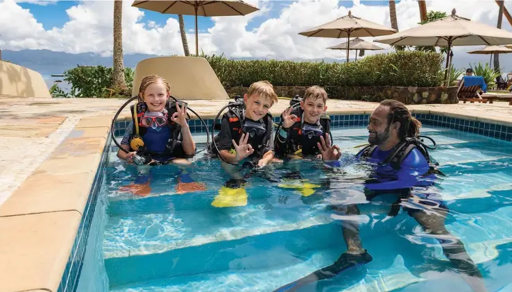  ?? Photo: Jean-Michel Cousteau Resort ?? Young tourists with a swim instructor take a dive in a pool at Jean Michel Cousteau Resort Fiji.