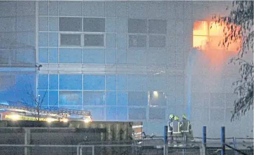  ?? Picture: George McLuskie. ?? Firefighte­rs tackle the blaze at the height of the drama in St Andrews last night.