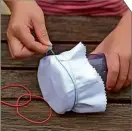  ??  ?? 3
Carefully stretch the dishcloth over the larger end of the bottle and fix it in place with elastic bands. Make sure the cloth is taut.