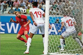  ?? ALASTAIR GRANT/THE ASSOCIATED PRESS ?? England’s Harry Kane scores his side’s 2nd goal against Tunisia during a Group G World Cup match in the Volgograd Arena on Monday in Volgograd, Russia.